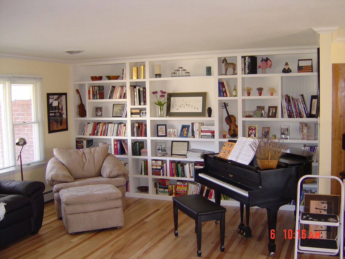 built-in wall length music room white bookshelves