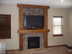 stone and wood fireplace remodel with TV nook