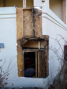 This shows exposed water damage on the exterior of a house.
