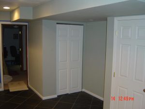 This is a basement finish hallway with doors and a closet.