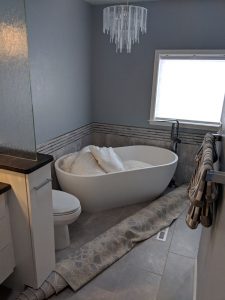 This is a beautiful free-standing tub and chandelier in a complete bathroom remodel.