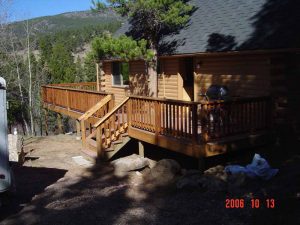 This picture shows the front and deck of a cabin remodel.