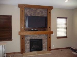 This is a custom stone fireplace with a wood surround.