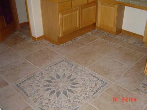 This shows a custom inlaid tile pattern in a kitchen floor
