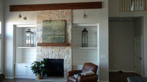 This shows a custom built fireplace and shelves.